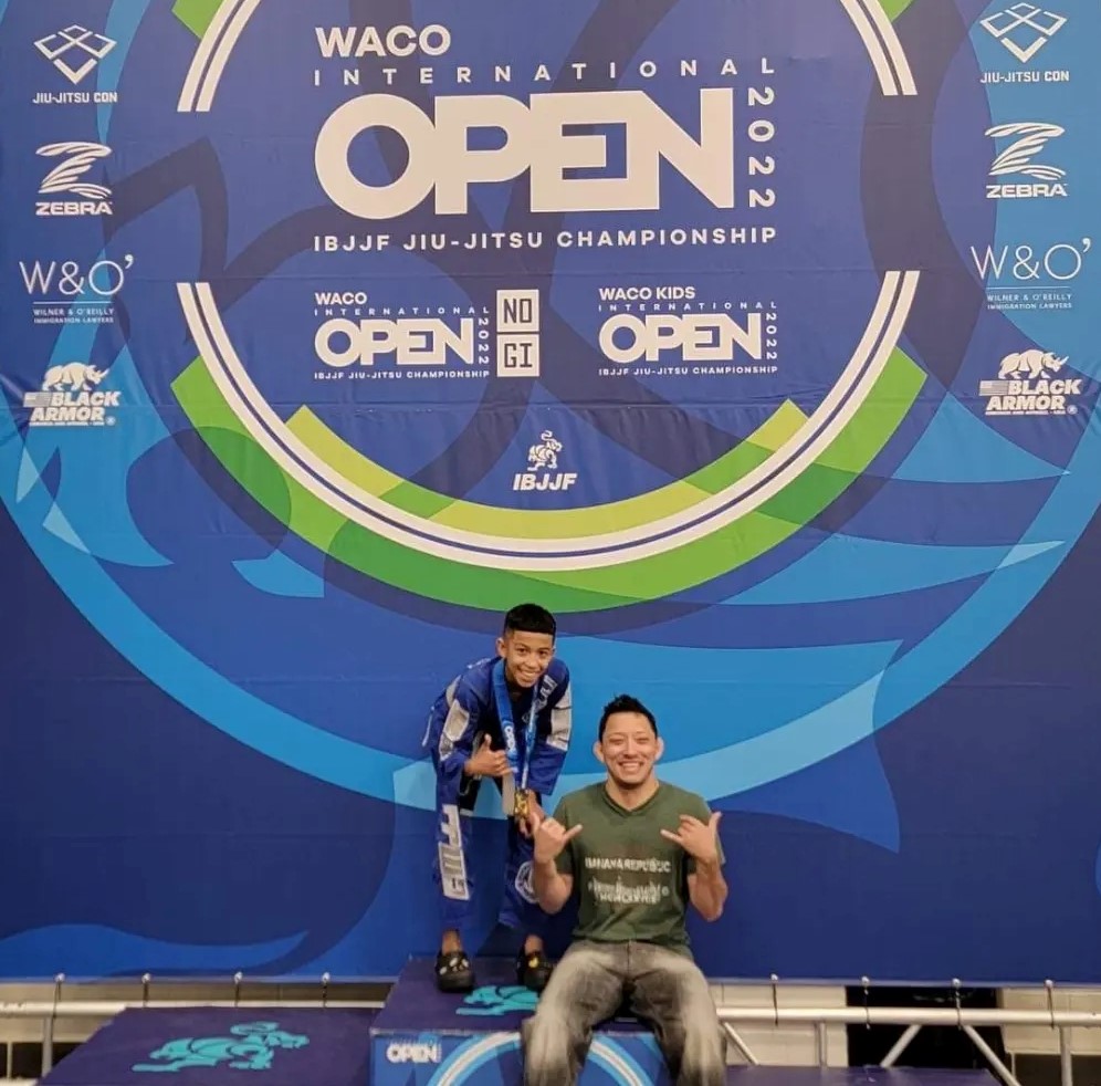 Coach Carlos celebrating with a young jiu-jitsu competitor